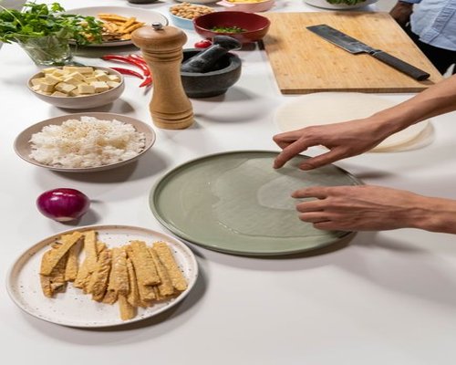 Fresh local ingredients including green vegetables, tofu, and tempeh prepared for cooking